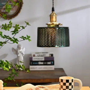 Mid-century modern green glass pendant light above study desk with books and plants