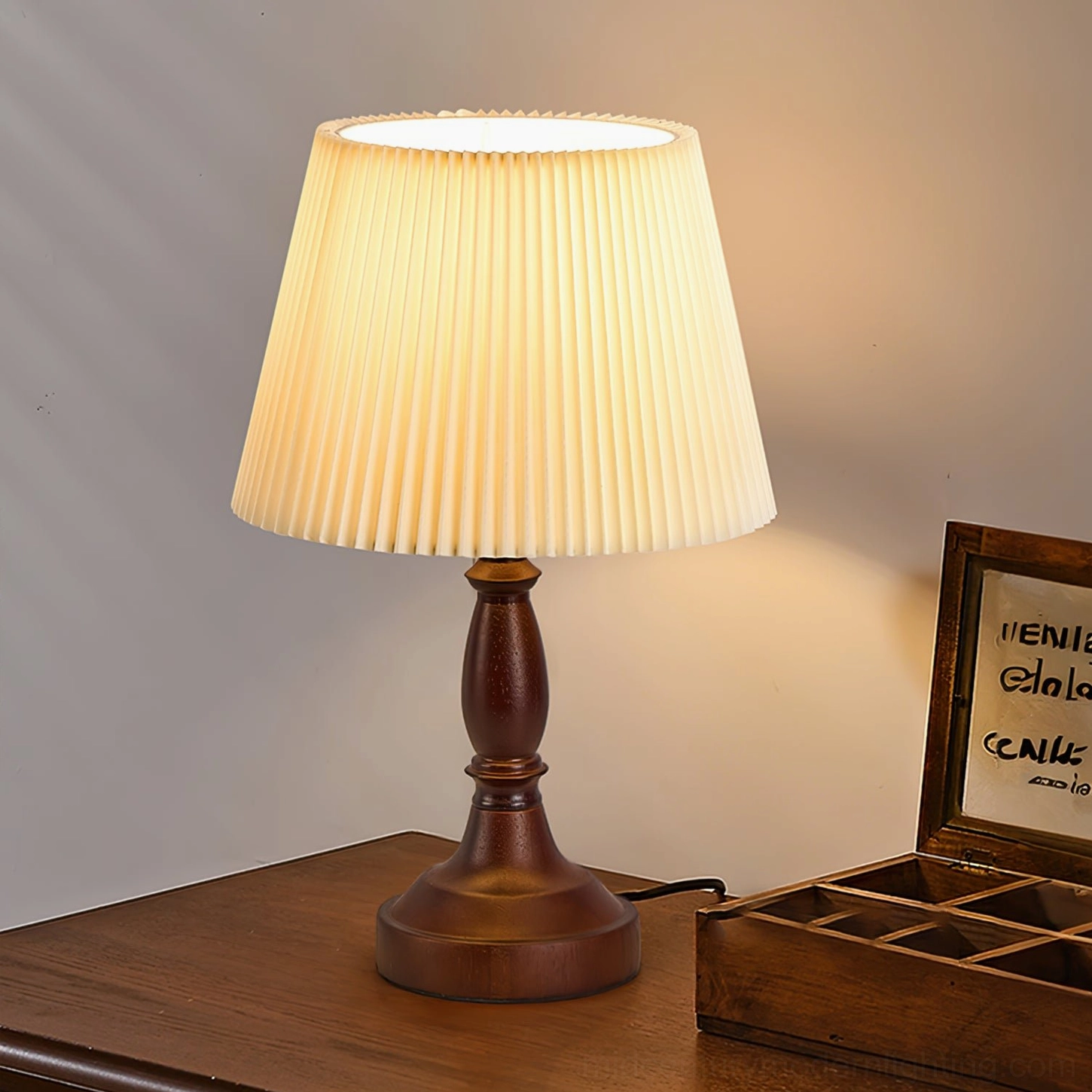 Table lamp with soft warm lighting beside framed photograph and stationery creating refined home office ambiance