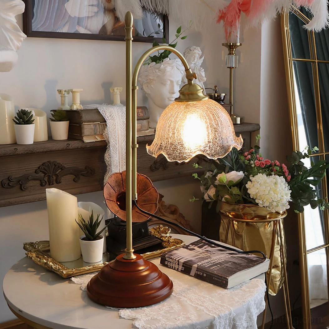 Illuminated vintage table lamp creating cozy ambient light, round table with candles and books nearby