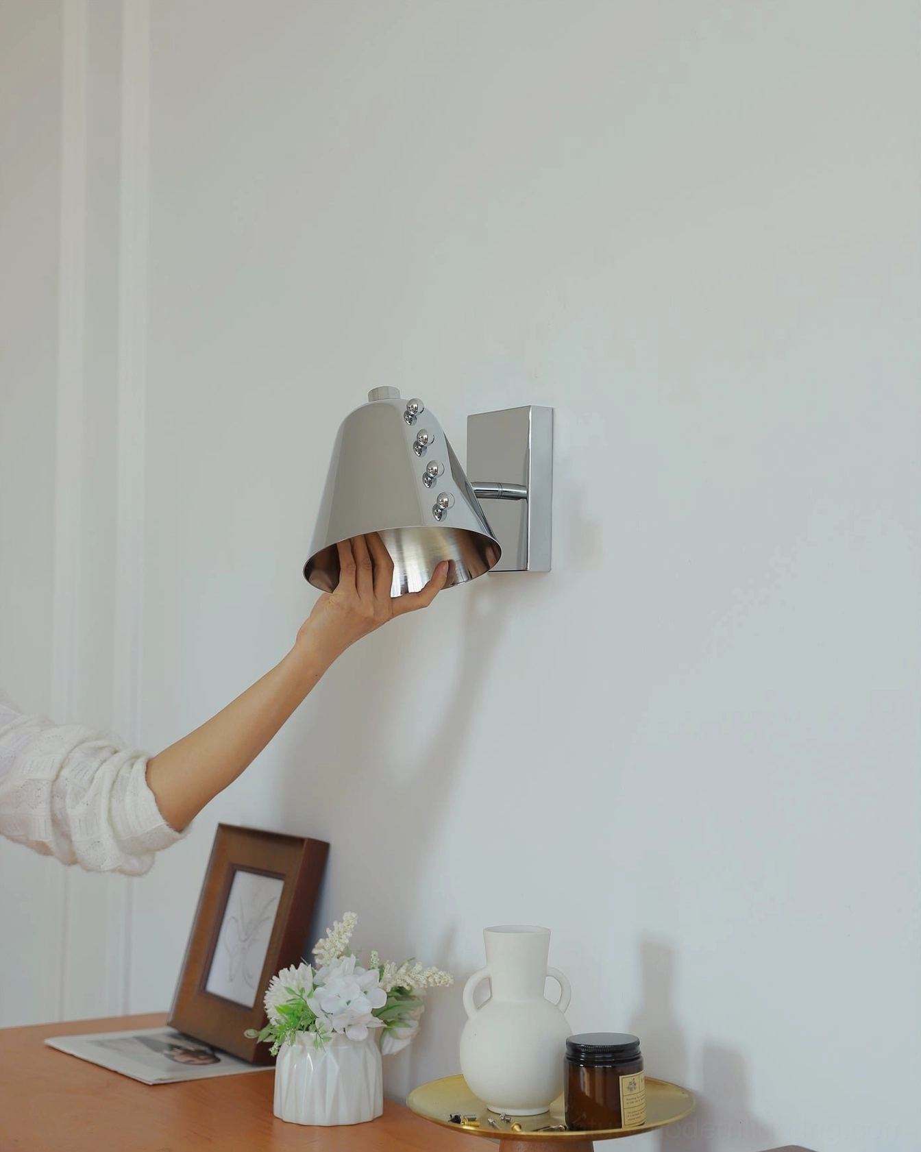 Mid-century modern wall lamp in lounge creating gallery-like minimalist atmosphere