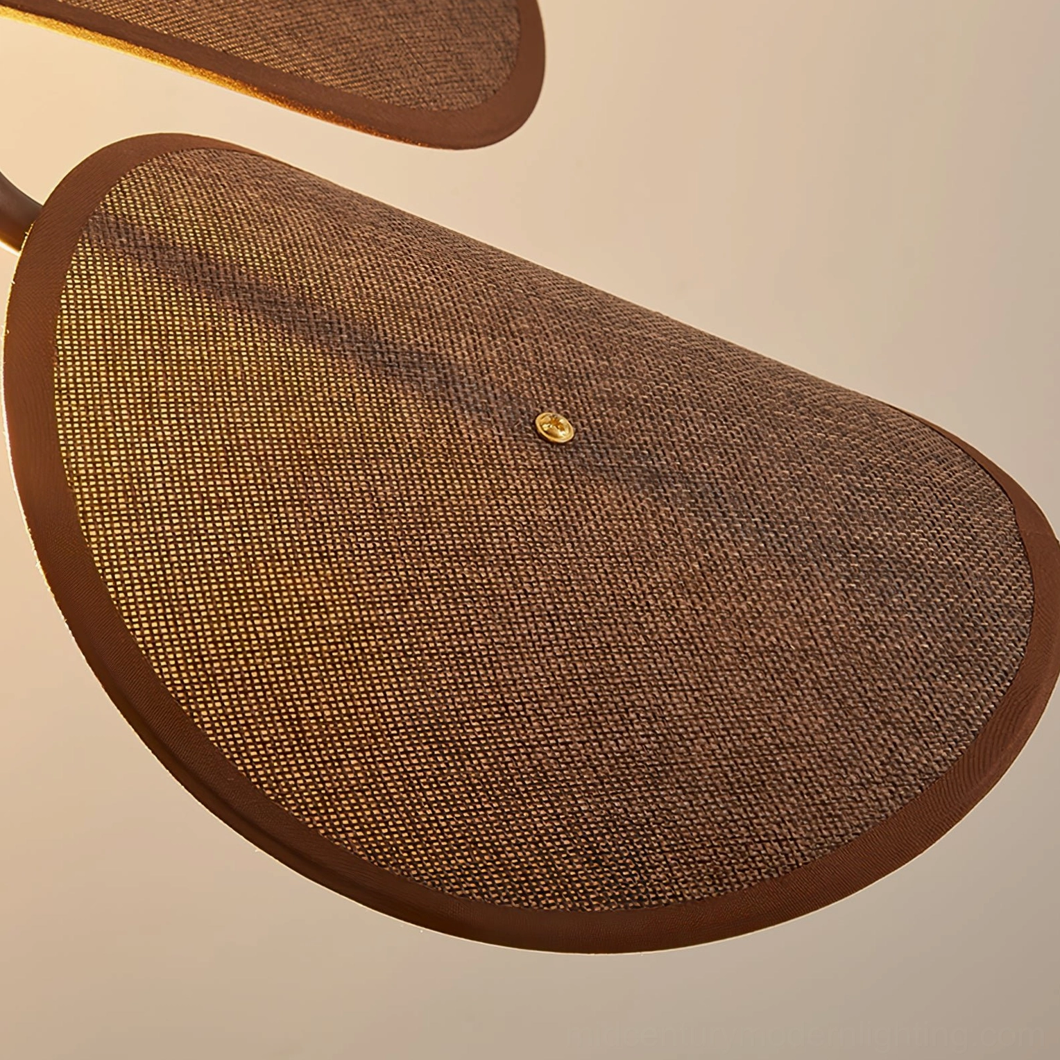 Fabric shade of Riankh wall lamp showing textured woven material and brown edge trim detail