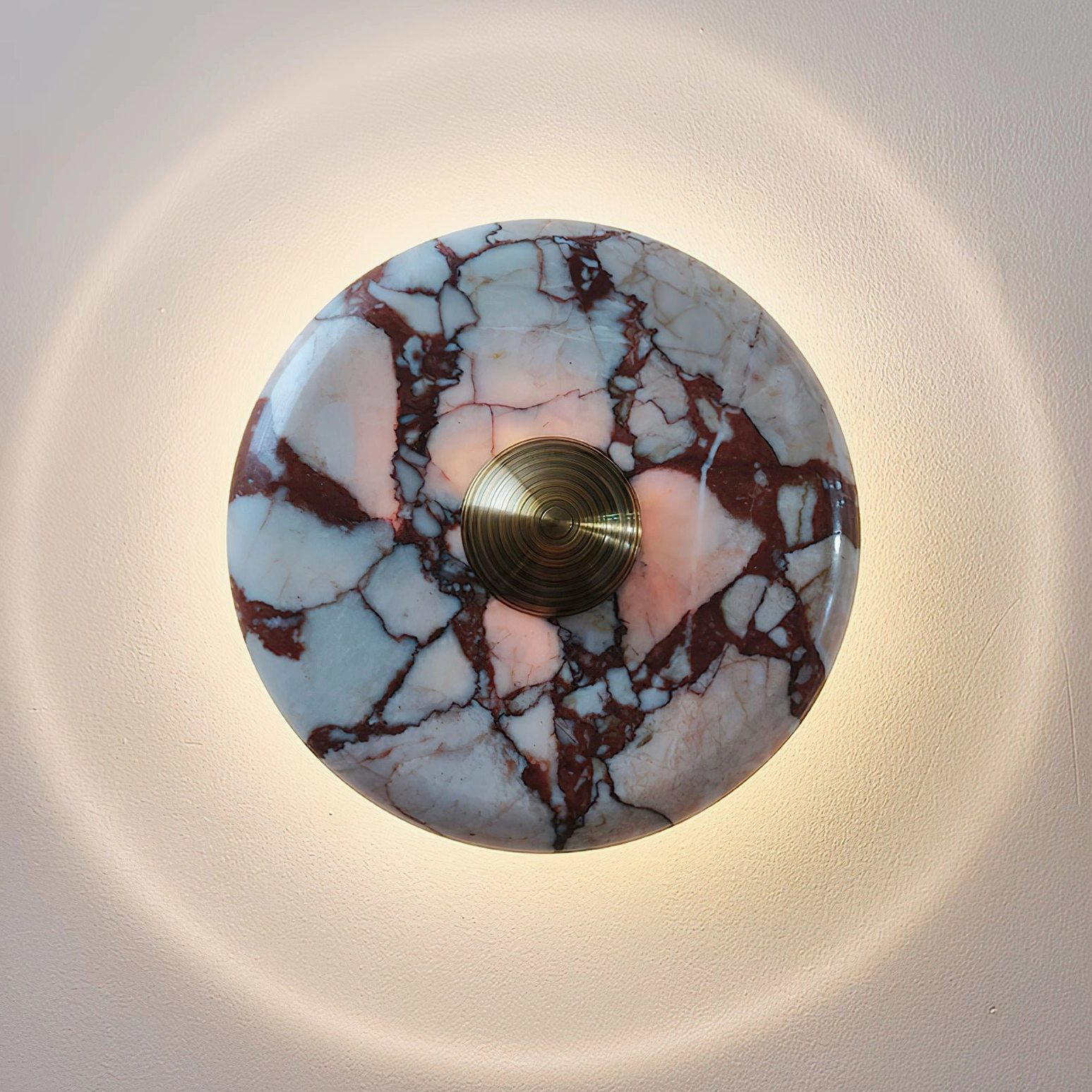 Mid-century modern marble wall lamp design with brass metalwork showing sculptural form and material detail
