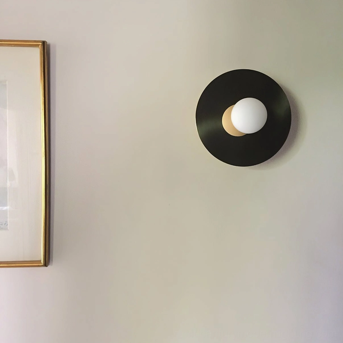 Mid-century modern disc and sphere wall lamp featuring frosted glass and metal construction