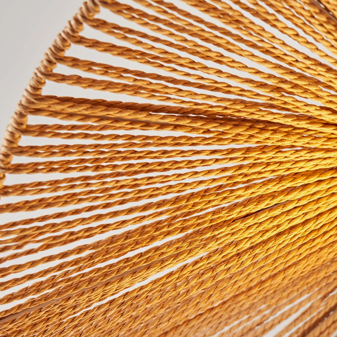 Mid-century modern Emmi rope pendant lamp with warm ambient lighting in contemporary home decor space
