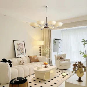 Multi-arm glass chandelier in warm mid-century modern living room with neutral vintage French minimalist decor - ambient room view