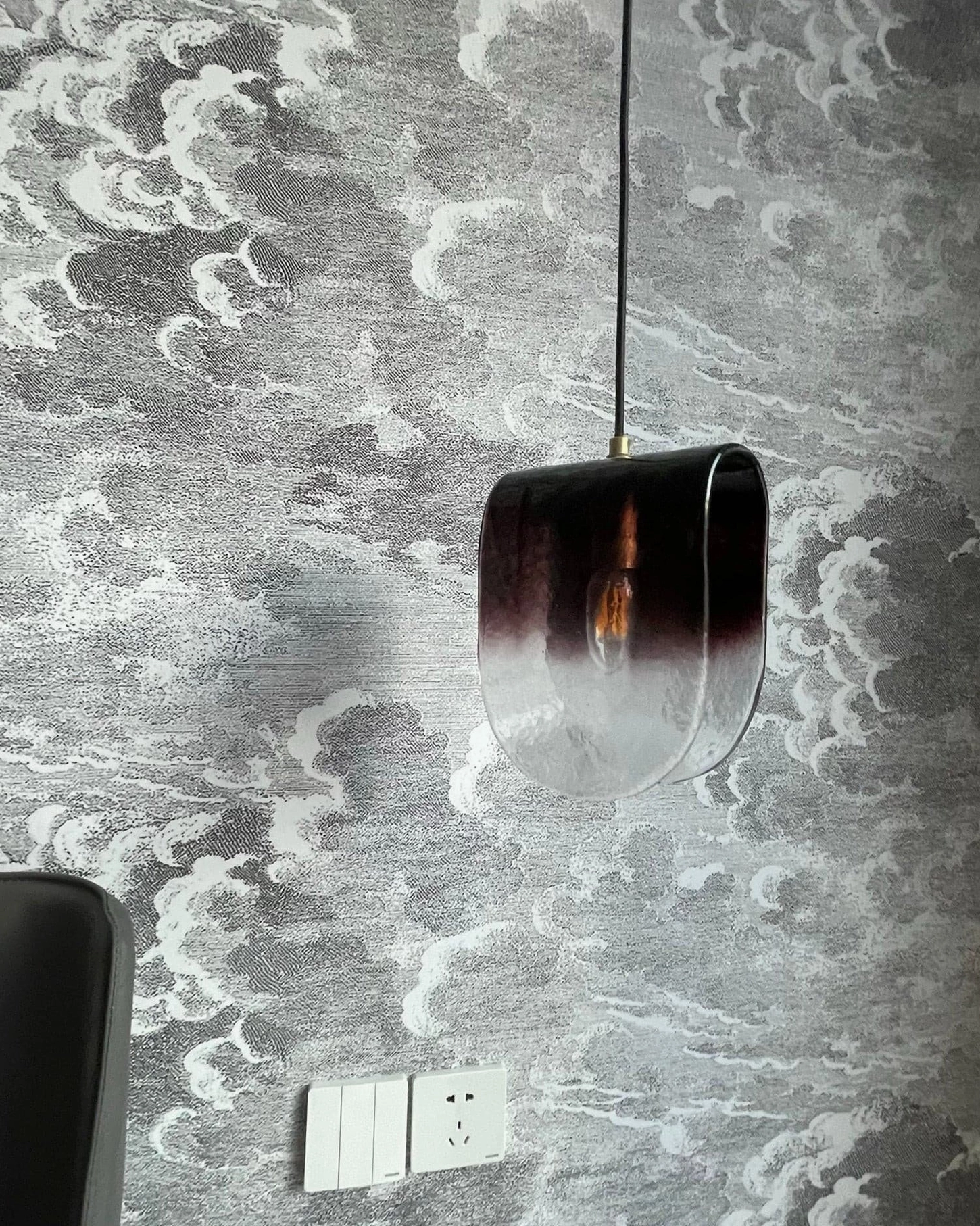 Mid-century modern inspired pendant light with hand-blown glass and vintage aesthetic appeal