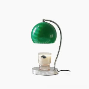 Scandinavian sphere table lamp with chrome metal base and glass globe shade on white studio background