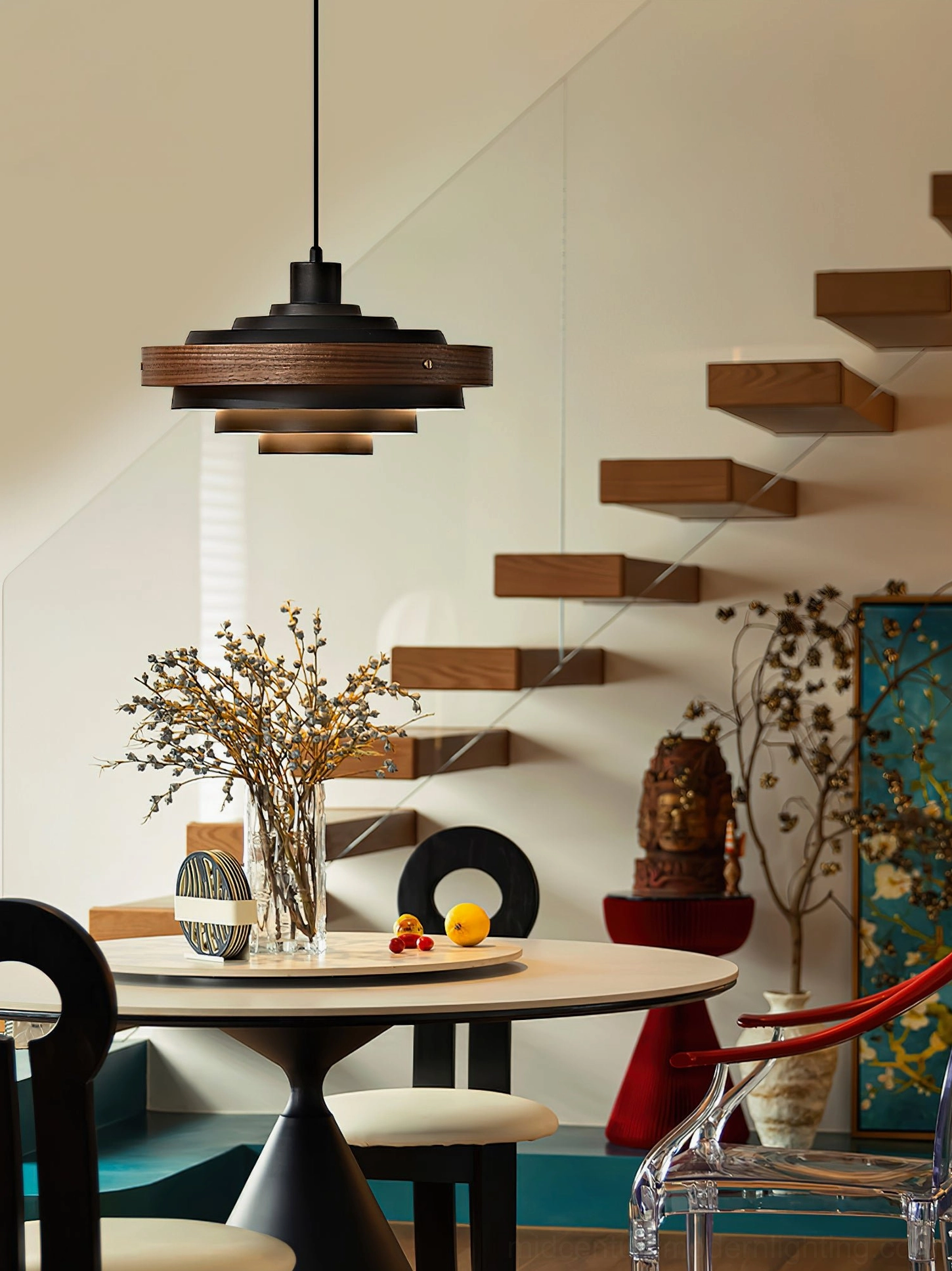 Layered pendant light with black metal arm and wood shade in mid-century dining area with stairs