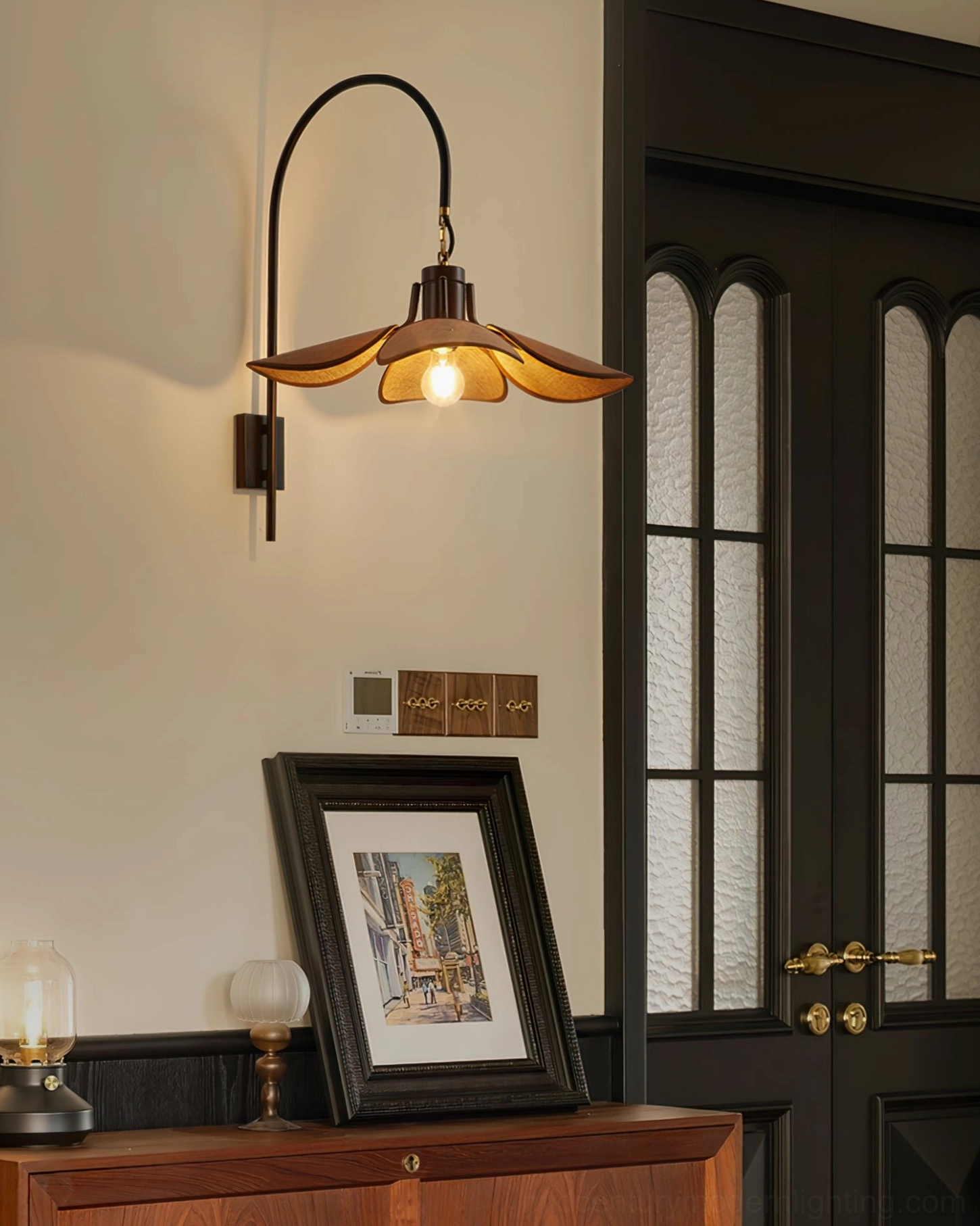Mid-century modern wall sconce mounted in home entryway with dark wood vintage decor
