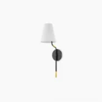Mid-century modern black and brass wall sconce with white fabric shade, low side angle view showcasing two-tone finish