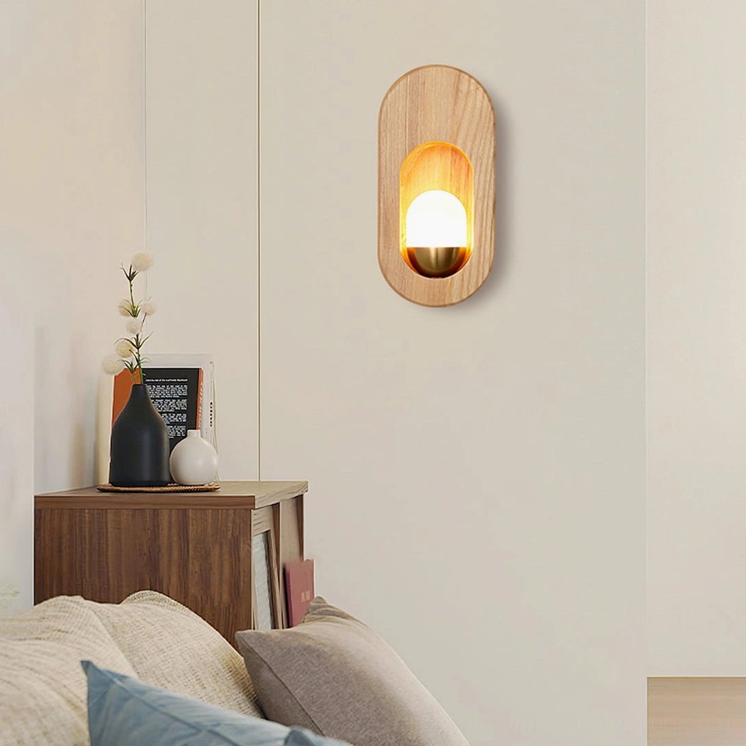 Mid-century modern wooden wall lamp in living room above side cabinet with flower vase and books
