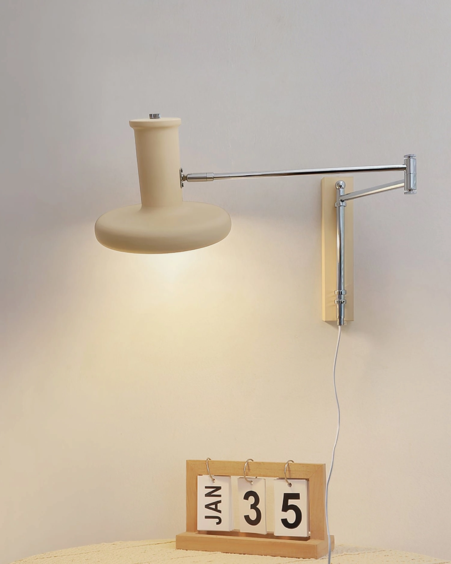 Mid-century modern wall-mounted swing arm light fixture showcasing vintage aesthetic with contemporary plug-in functionality