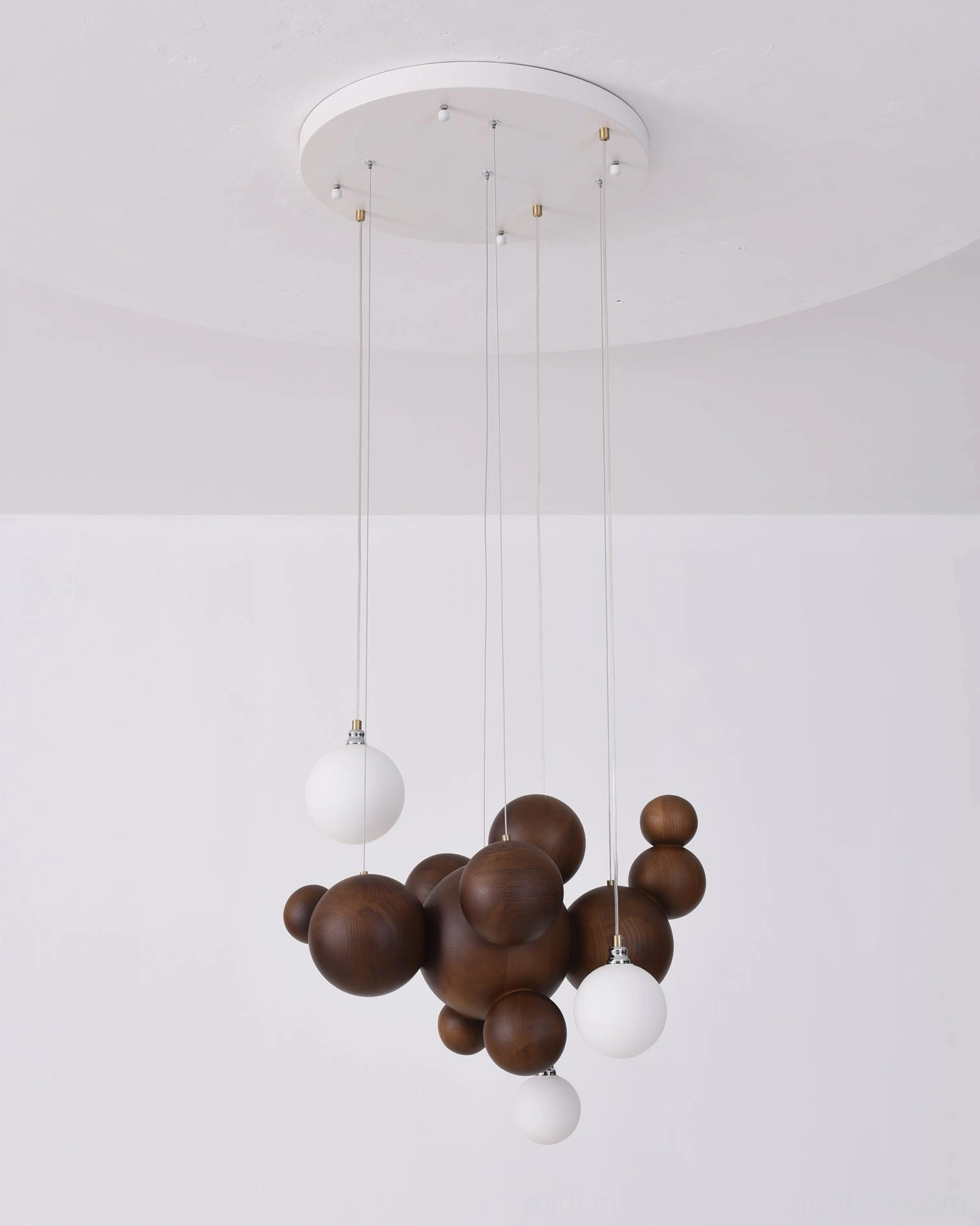 Wood ball cluster pendant light showing mid-century modern aesthetic with multiple illuminated frosted glass diffusers
