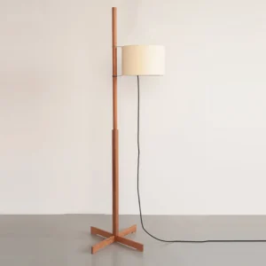 Minimalist wood floor lamp with fabric shade showing sleek pole design and black power cord