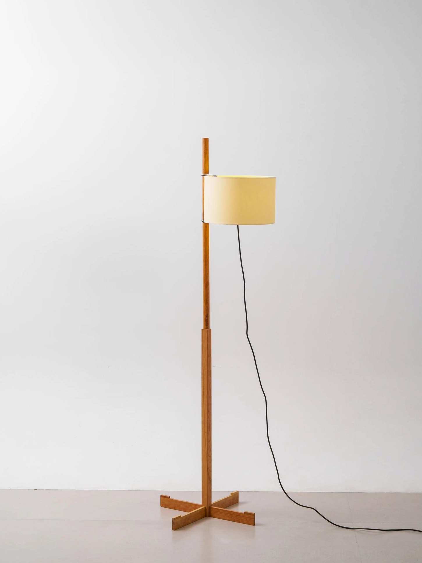 Minimalist wooden floor lamp with fabric shade displaying mid-century modern aesthetics