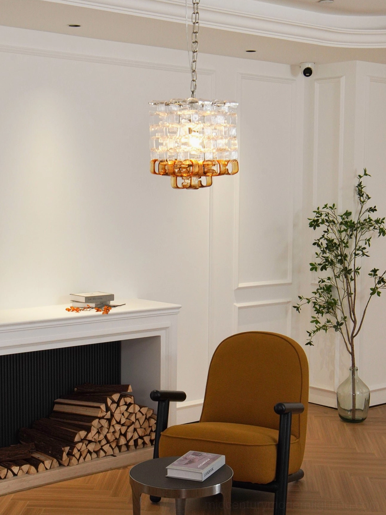 Elodie Murano chandelier hanging above seating area in elegant vintage-modern living room with fireplace, warm ambient lighting