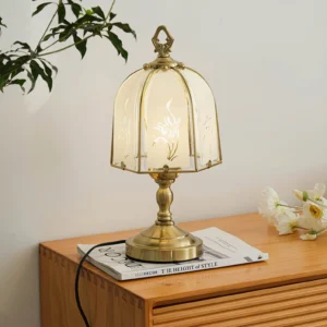 Vintage orchid glass lamp displayed on wooden side table with plant decor and magazines