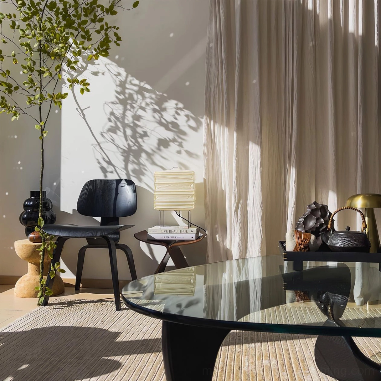 Mid-century modern paper table lamp in minimalist living room with black lounge chair and glass coffee table, contemporary interior design styling