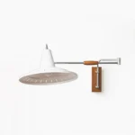 Paperclip swing arm wall lamp with mid-century modern design, featuring wood and chrome articulated elbow joint on white background