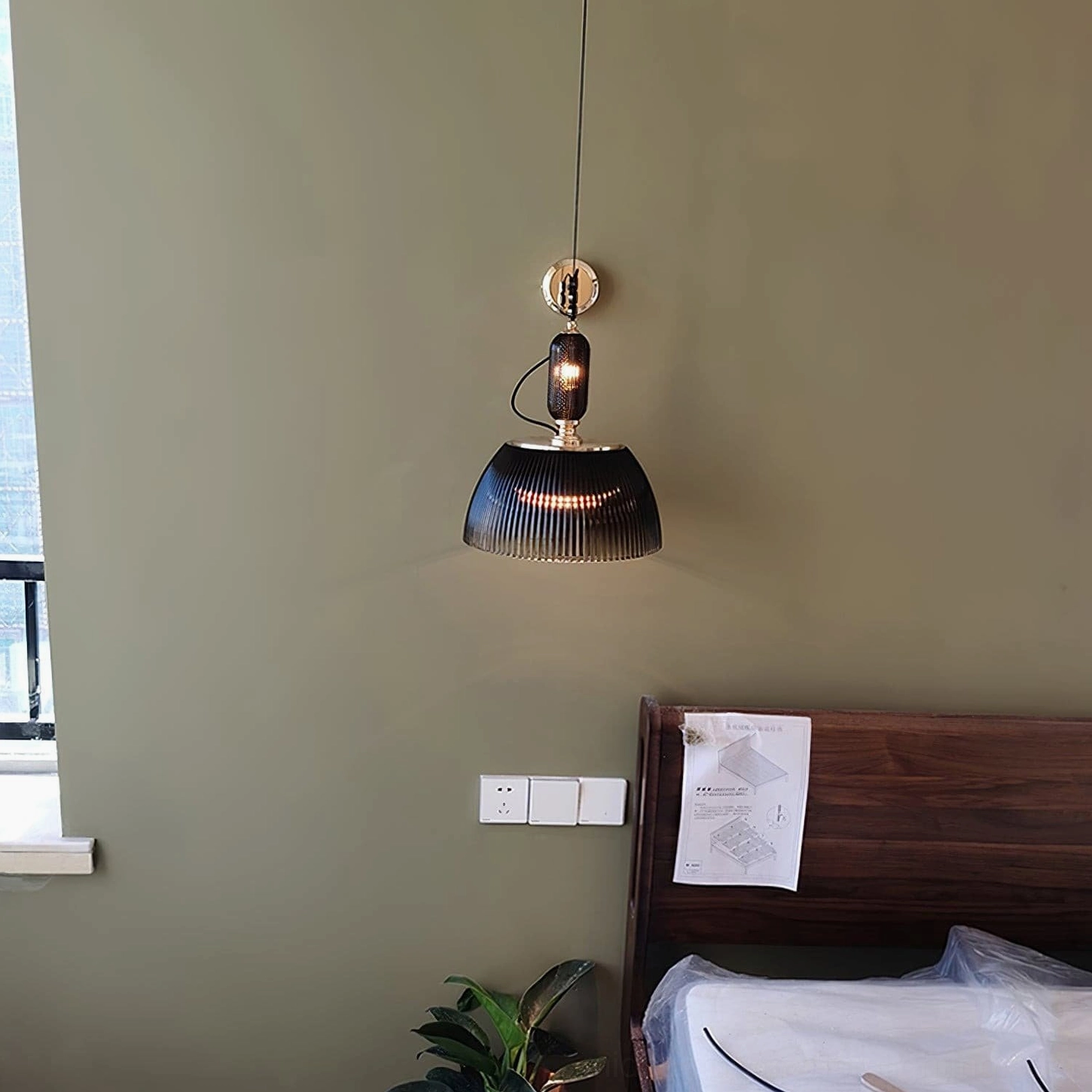 Mid-century modern hanging lamp showing interior metal fixture and glass dome assembly from below
