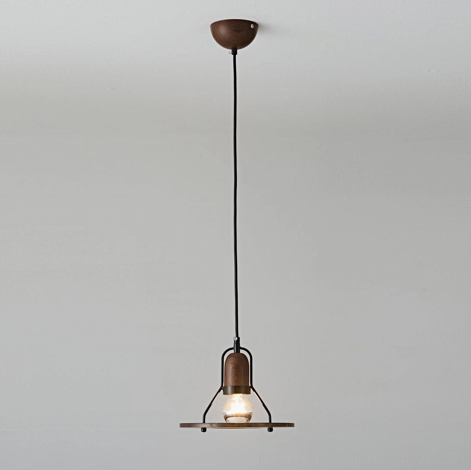 Compact disc-shaped pendant lamp shade in matte black metal, front view studio photography