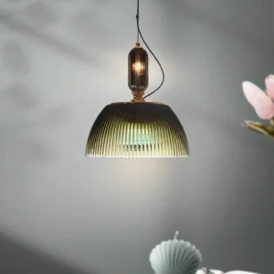 Close-up low angle view of mid-century modern pendant light showing exposed Edison bulb through textured ribbed glass shade