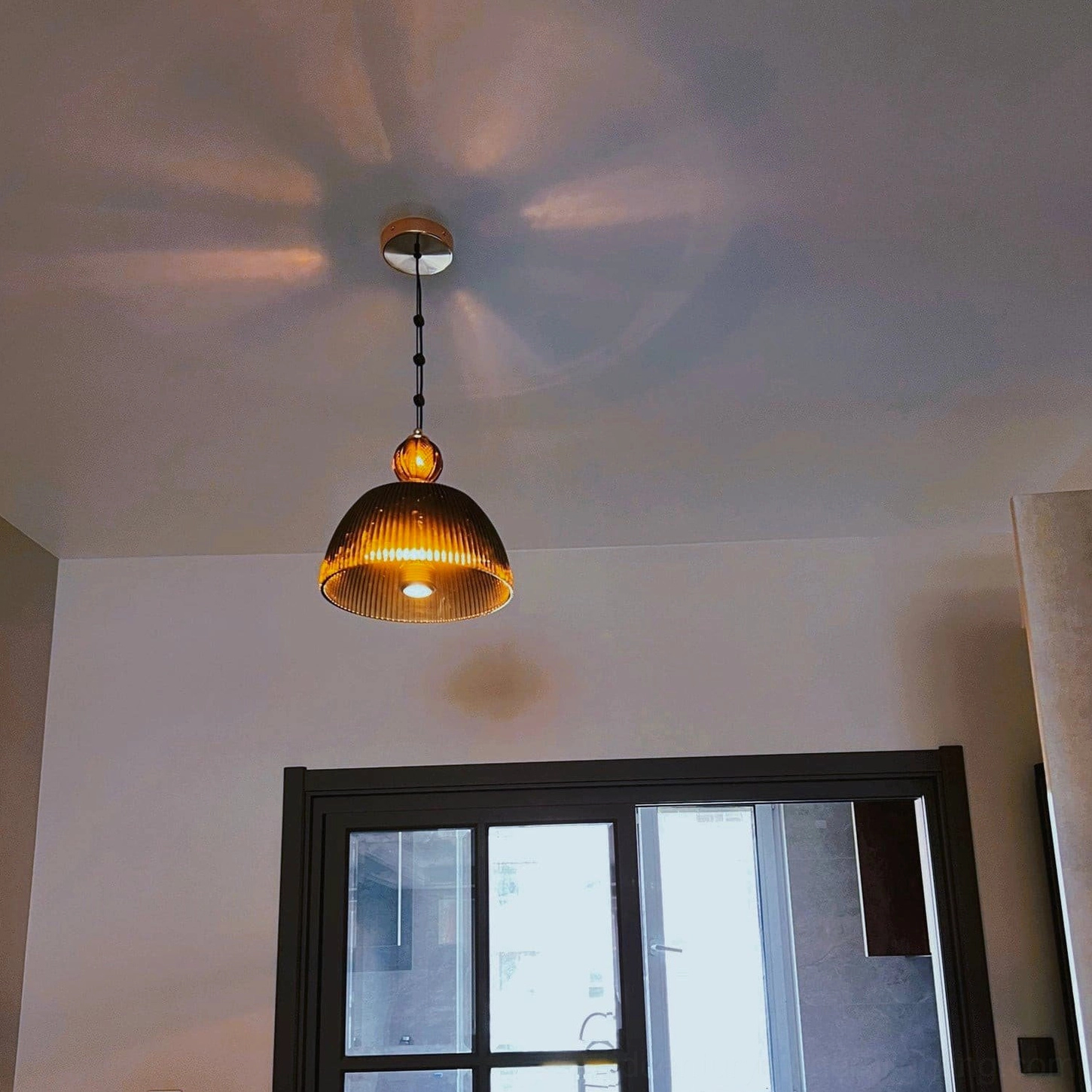 Vintage mid-century pendant lamp installed in modern home demonstrating timeless design compatibility