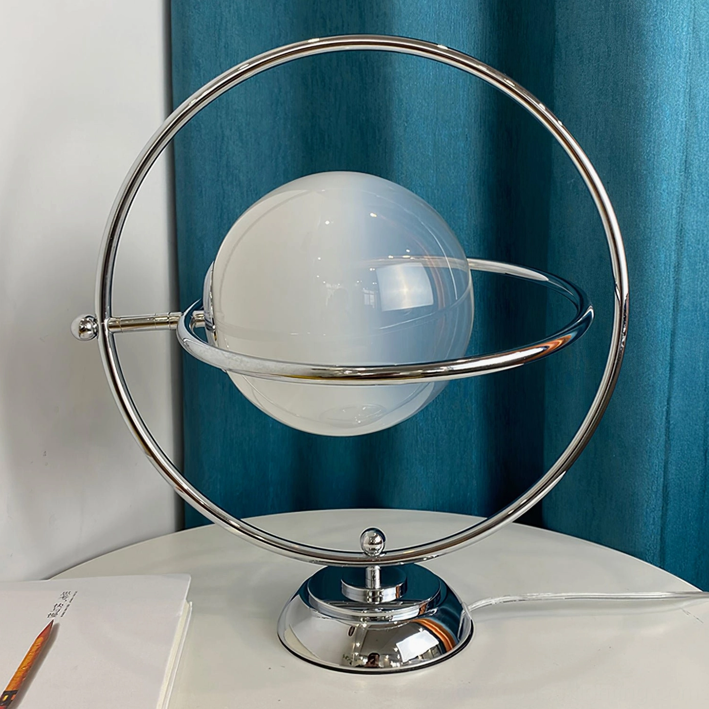 Mid-century modern planet table lamp with polished frame on contemporary furniture