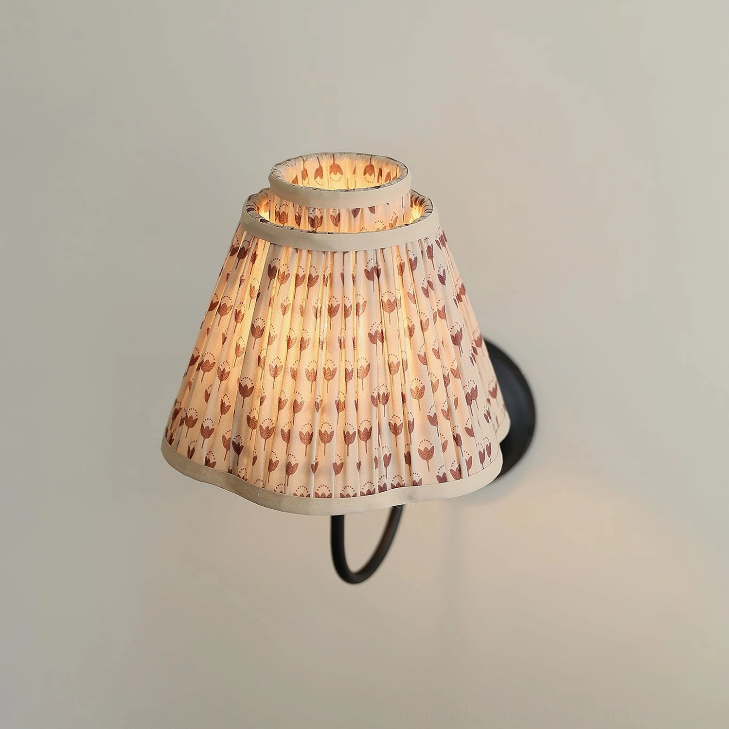 Mid-century modern pleated wall sconce mounted indoors, curved metal bracket installation view