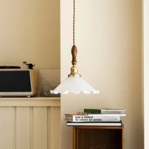 Mid-century modern ruffled pendant lamp installed in contemporary kitchen, brass and wood fixture above countertop with microwave