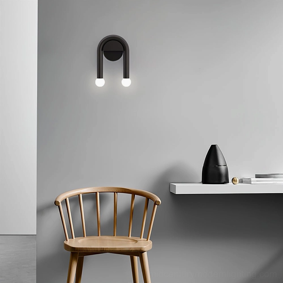 Minimalist black arched wall lamp side view installed above wooden shelf in contemporary corner space