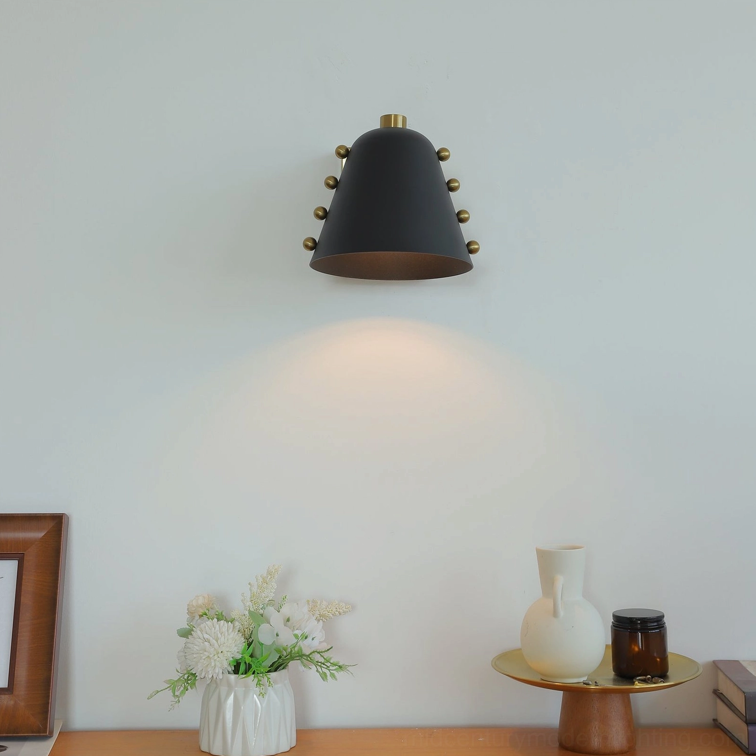 Mid-century modern wall sconce mounted on textured wall in contemporary interior setting
