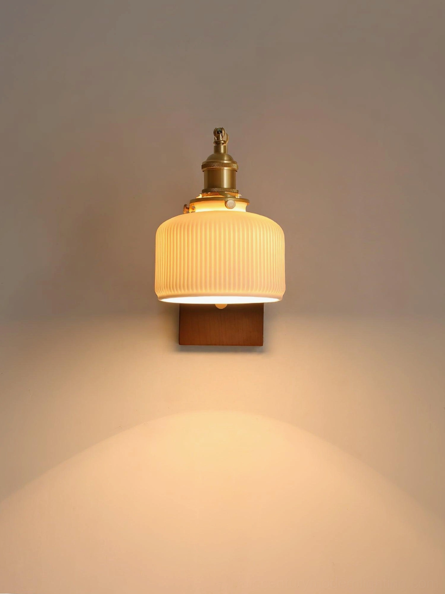 Close-up of mid-century modern wall sconce showing walnut wood base and brass mounting hardware