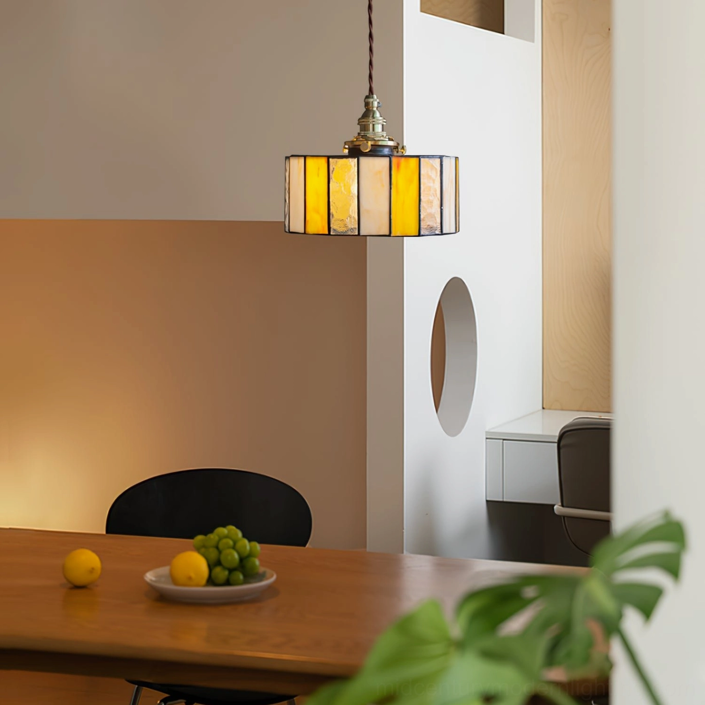 Mid-century modern amber stained glass drum pendant with warm diffused light and vintage Tiffany aesthetic