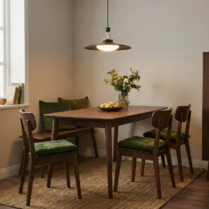 Eden swing arm pendant light illuminating warm vintage dining room with wooden table set and green cushioned chairs, demonstrating ambient dining lighting