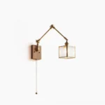 Mid-century swing arm wall lamp with brass hardware, ribbed square glass shade, and light wood base - front studio view