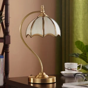 Mid-century modern umbrella lamp three-quarter angle showing curved brass pole and glass panel shade