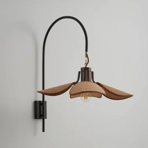 Mid-century modern wall sconce with exposed vintage Edison bulb and sculptural metal arm, three-quarter view