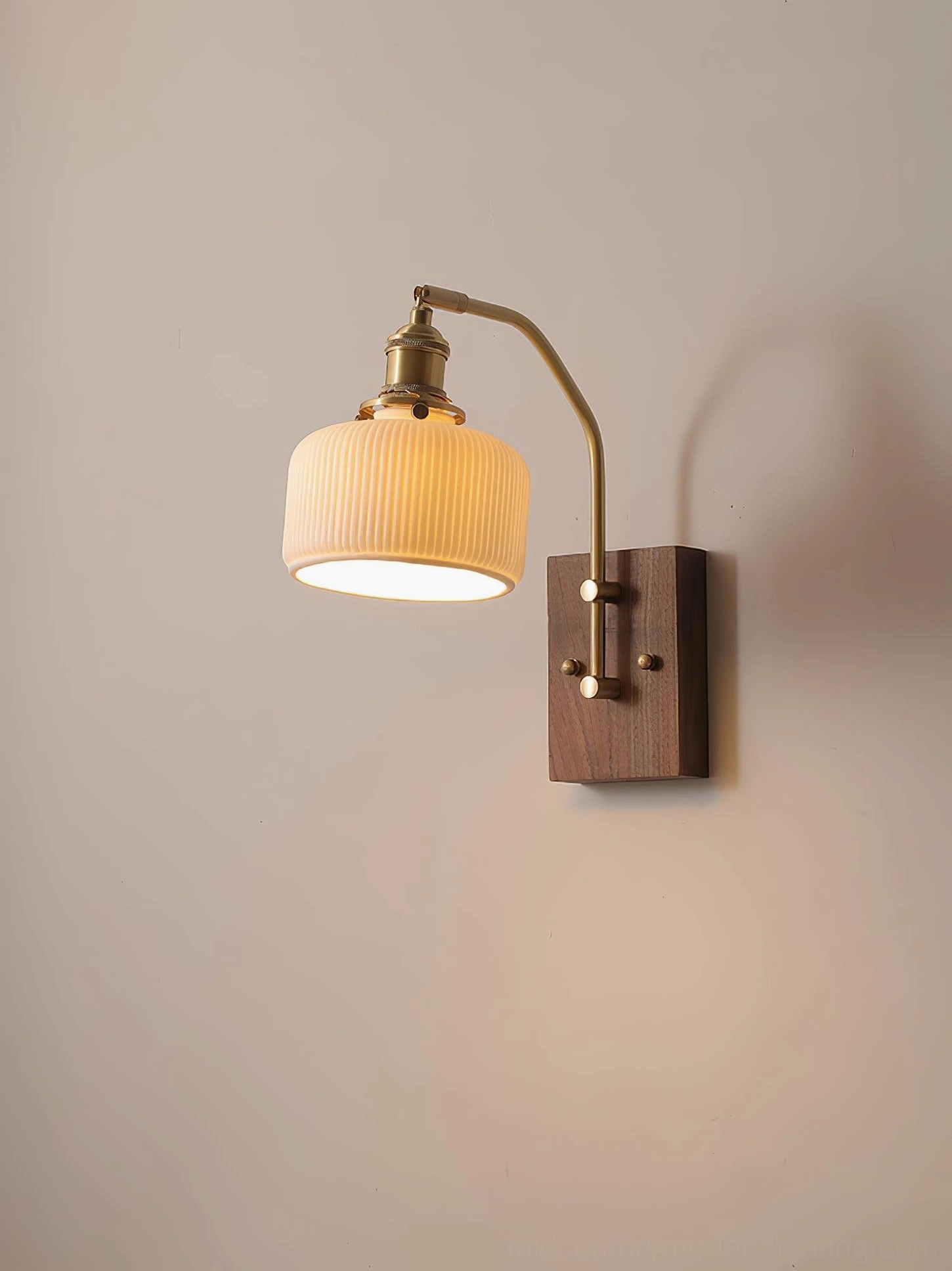 Compact mid-century modern wall lamp side view showing ribbed ceramic shade and brass arm detail