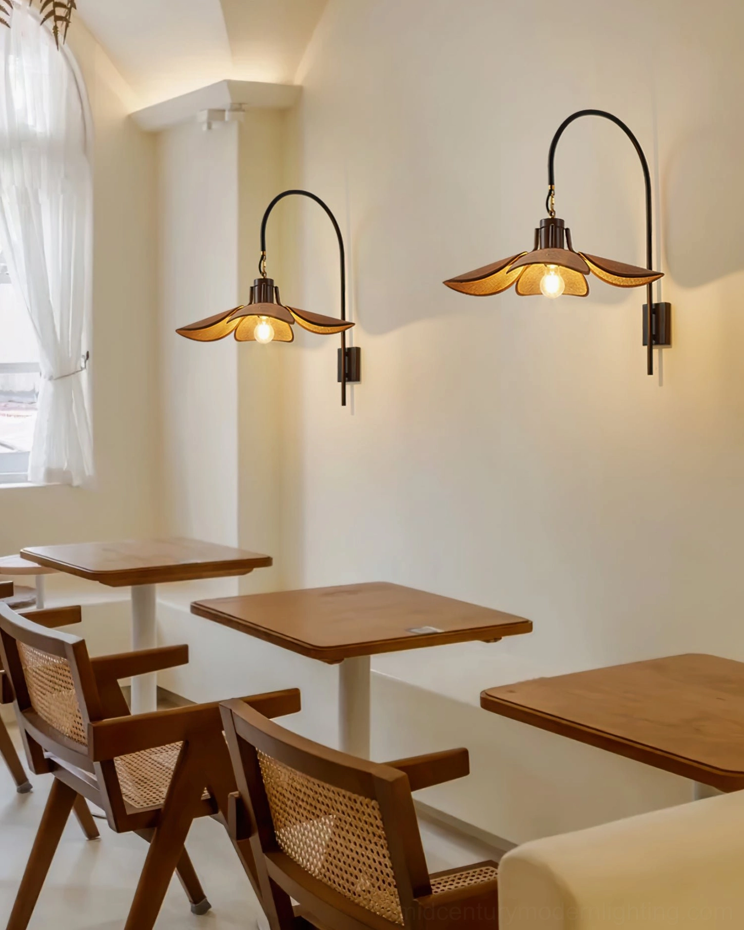 Dual mid-century modern wall lamps installed in coffee shop seating area with retro furniture