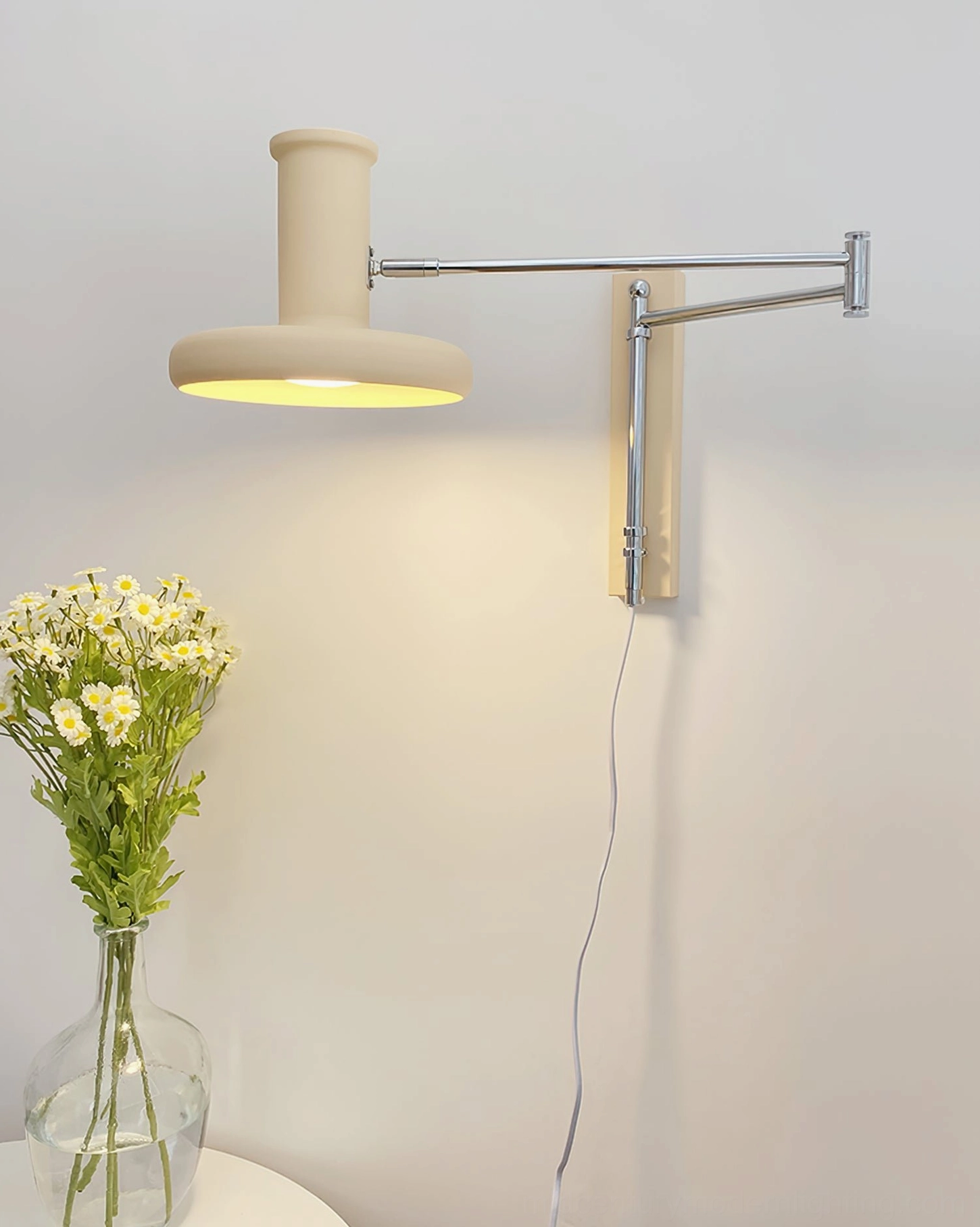 Plug-in wall lamp on side table corner in home decor setting with flowers, warm ambient glowing light illumination