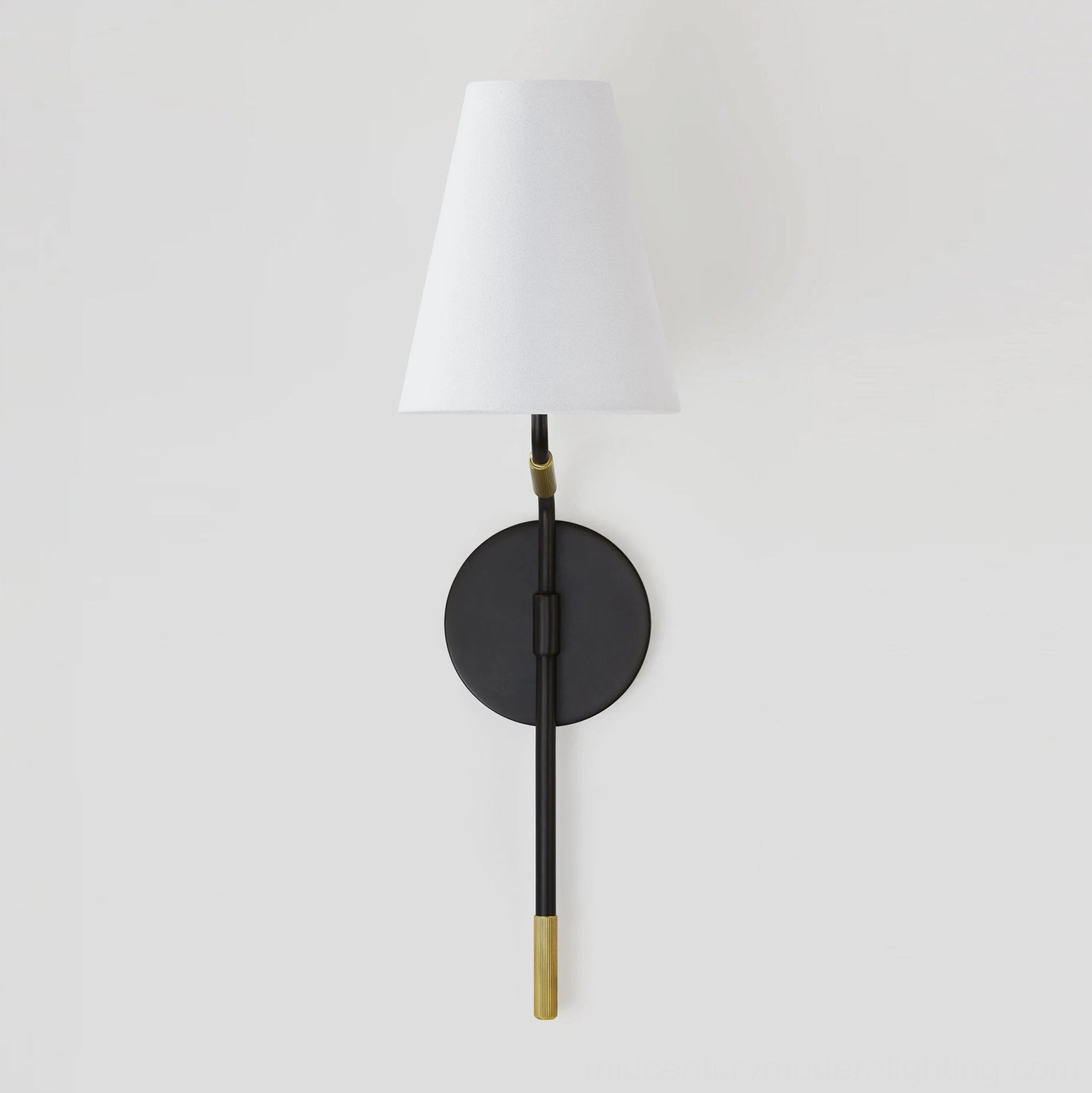 Mid-century modern wall light with exposed brass end cap and tapered white fabric shade, straight-on view