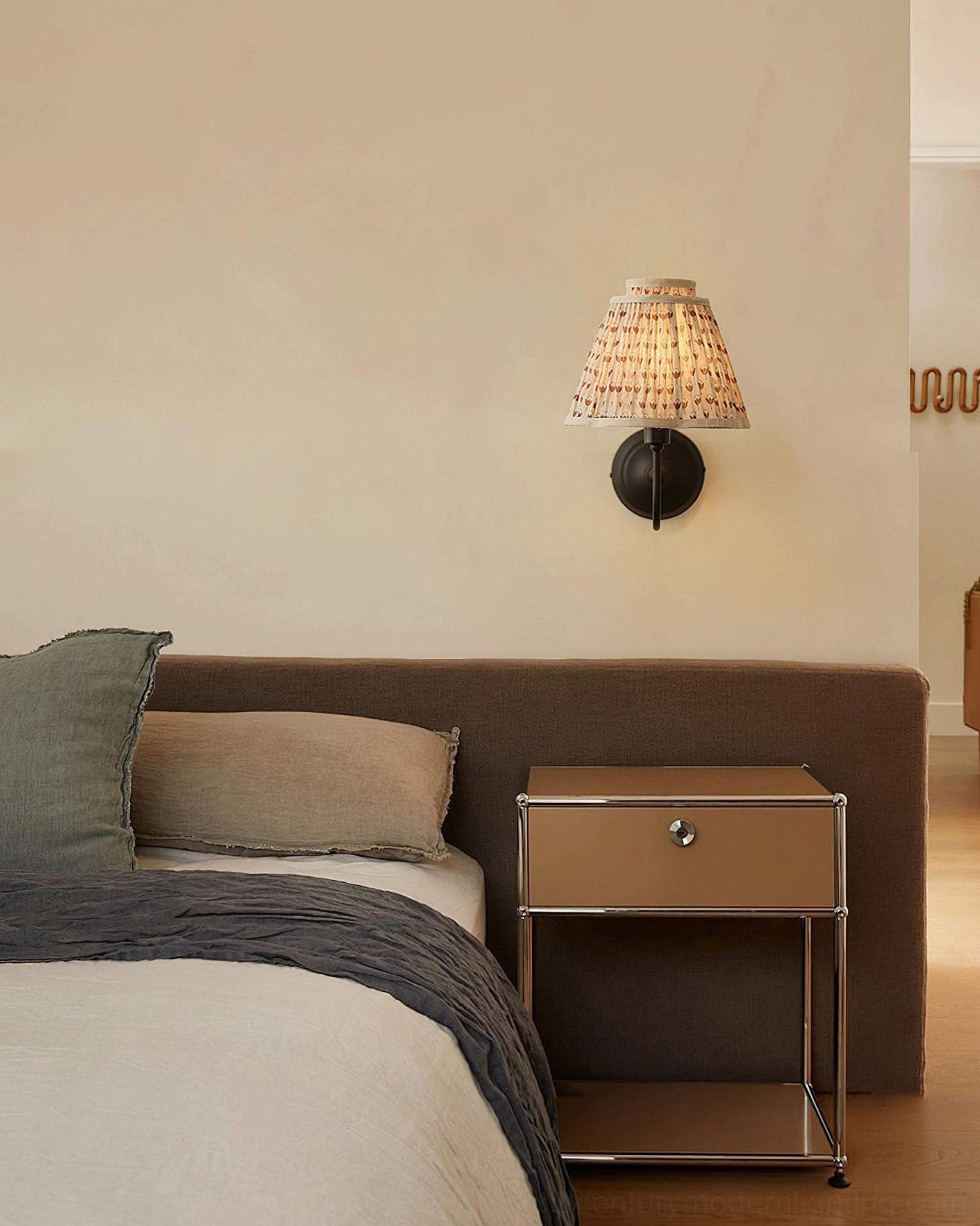 Mid-century modern wall sconce in minimalist bedroom with bed and nightstand, soft lighting