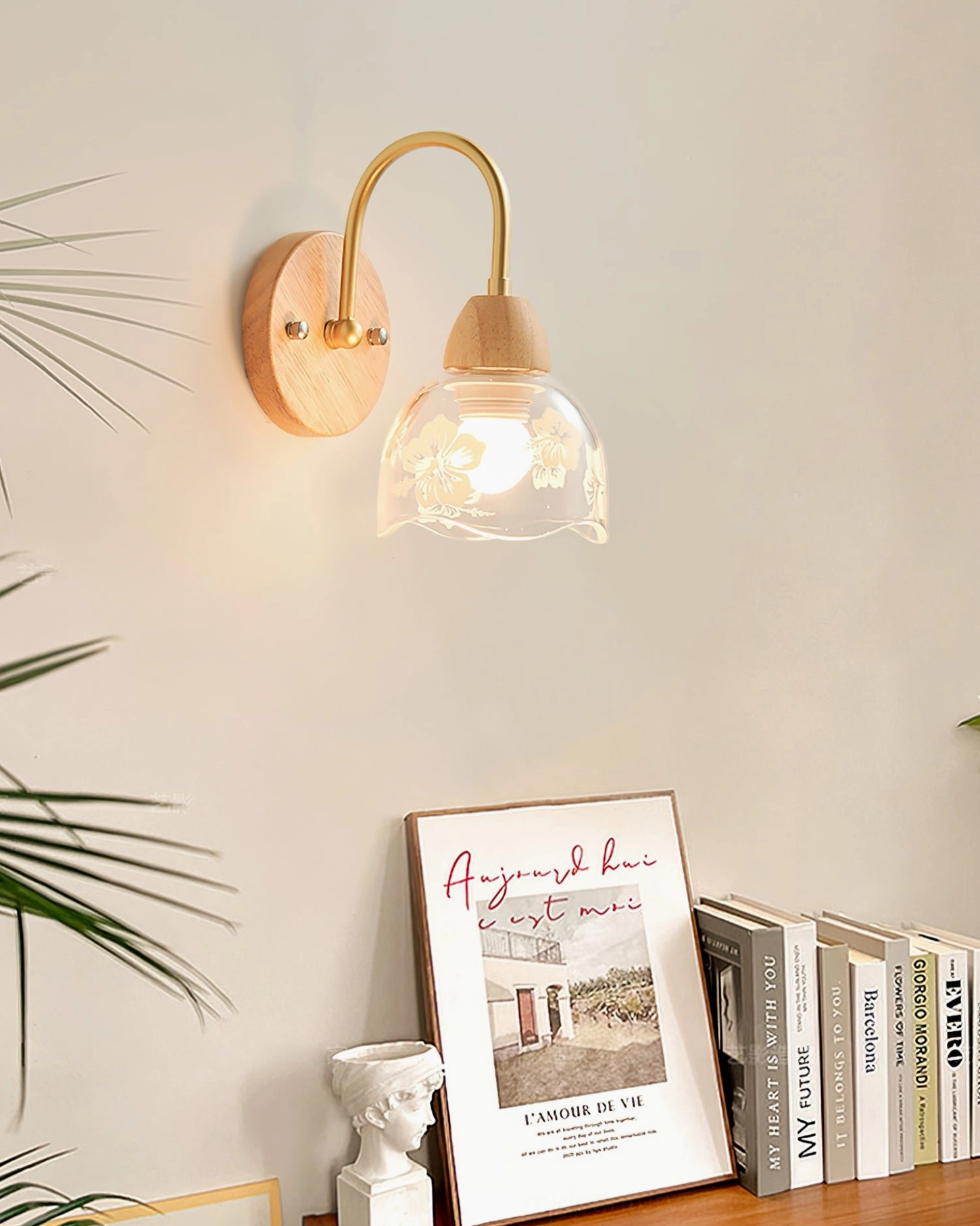 Nordic wall lamp positioned beside bookshelf with art books and decorative objects