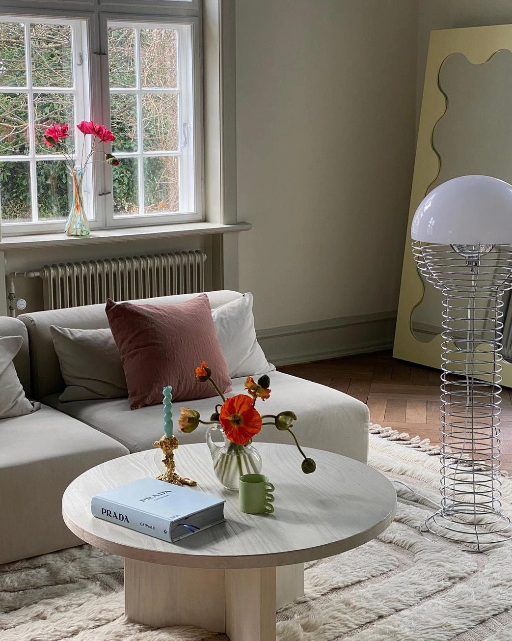 Mid-century wire floor lamp in bright residential living room with Scandinavian style decor and natural light