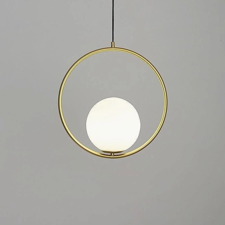 Mila brass pendant lamp with hand-blown frosted glass sphere, warm metal finish mid-century modern suspended light fixture