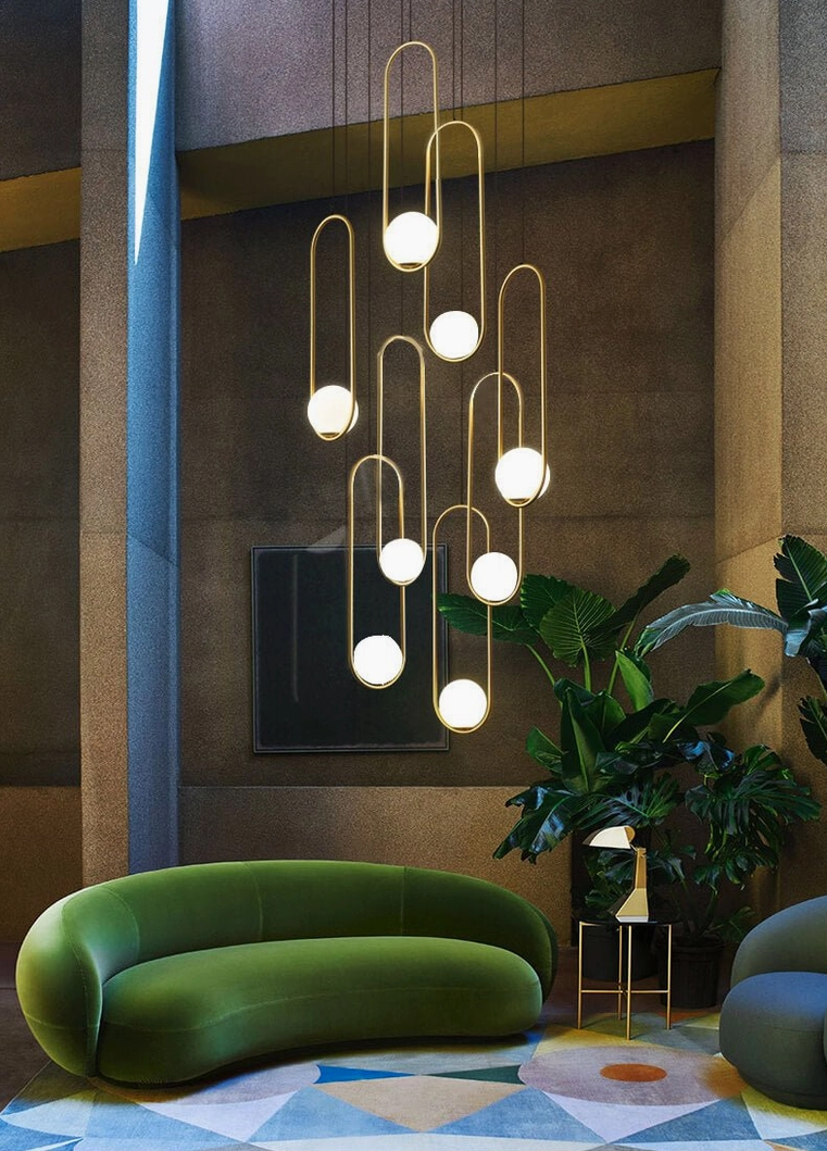 Mila brass finish pendant lamp cluster with warm earthy tones in luxury mid-century modern living room