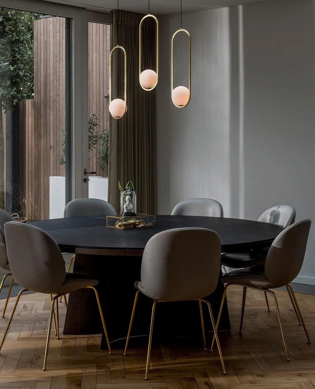 Slim modern Mila pendant lights with soft warm ambient lighting in formal dining room setting