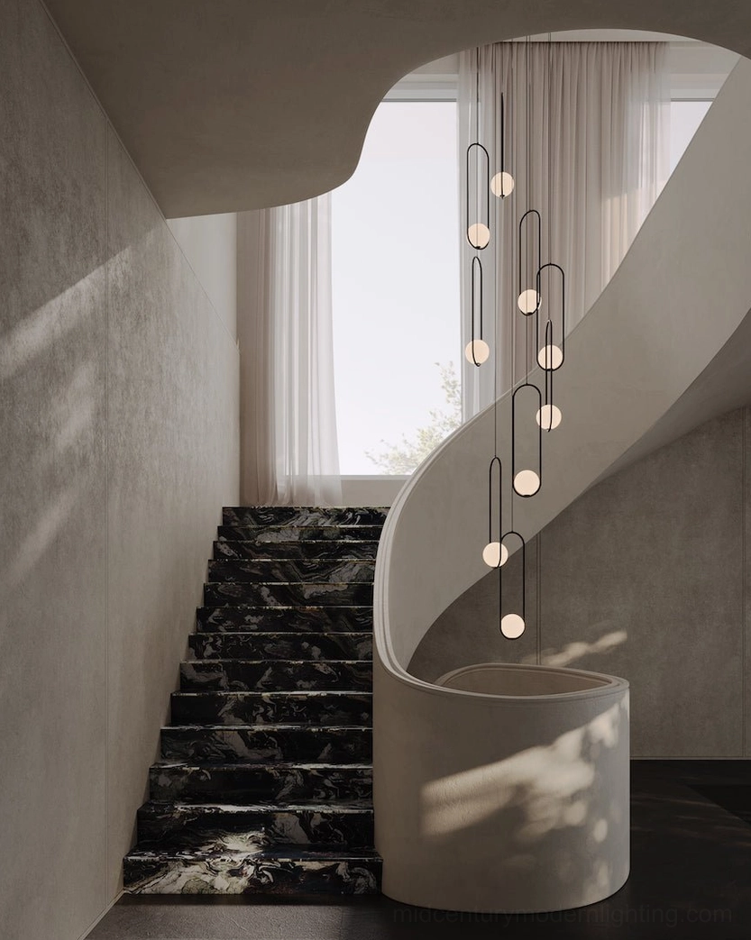 Mila long cluster pendant lamps with black frames displayed above marble staircase in bright modern interior
