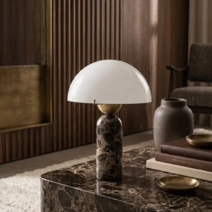 Milano marble table lamp creating warm ambient light on luxury living room coffee table, styled with dark marble tabletop and fluted wood wall accents